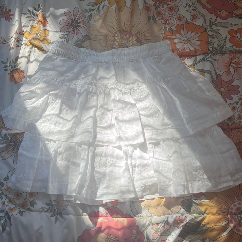 Has pretty detailing on it. Short, but long skirt. Never worn.In very good shape